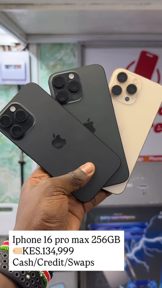 Premium iPhone Pro models held in hand in the showroom